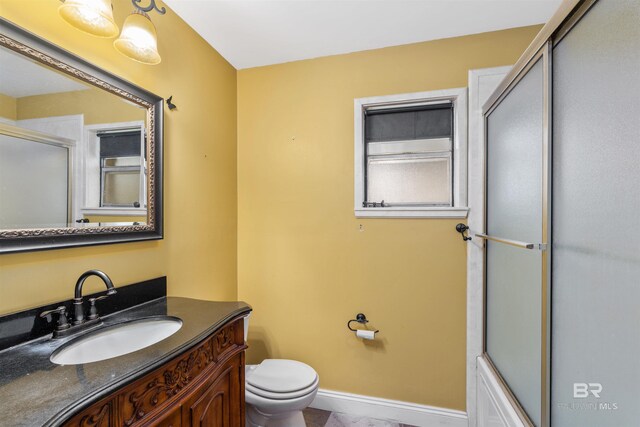 bathroom with tile floors, toilet, and vanity