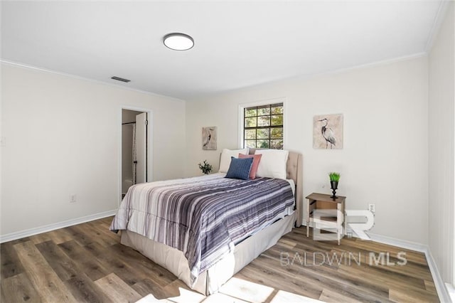 bedroom with hardwood / wood-style flooring