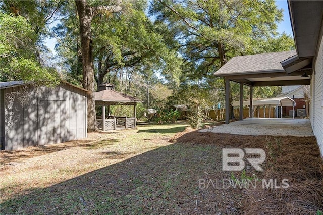 view of yard featuring a gazebo and a shed