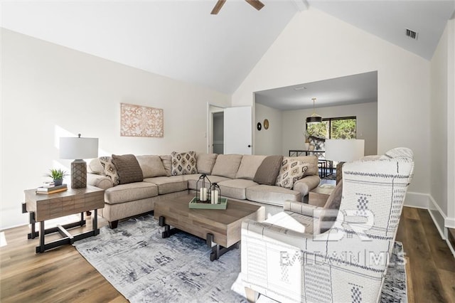 living room featuring ceiling fan, hardwood / wood-style floors, beamed ceiling, and high vaulted ceiling