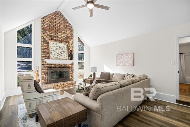 living room featuring vaulted ceiling with beams, ceiling fan, a fireplace, and hardwood / wood-style flooring