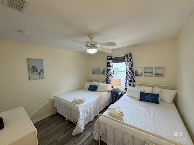 1117 W Lagoon Ave Unit 9, Gulf Shores, AL 36542 - bedroom with dark wood-style flooring, ceiling fan, and baseboards