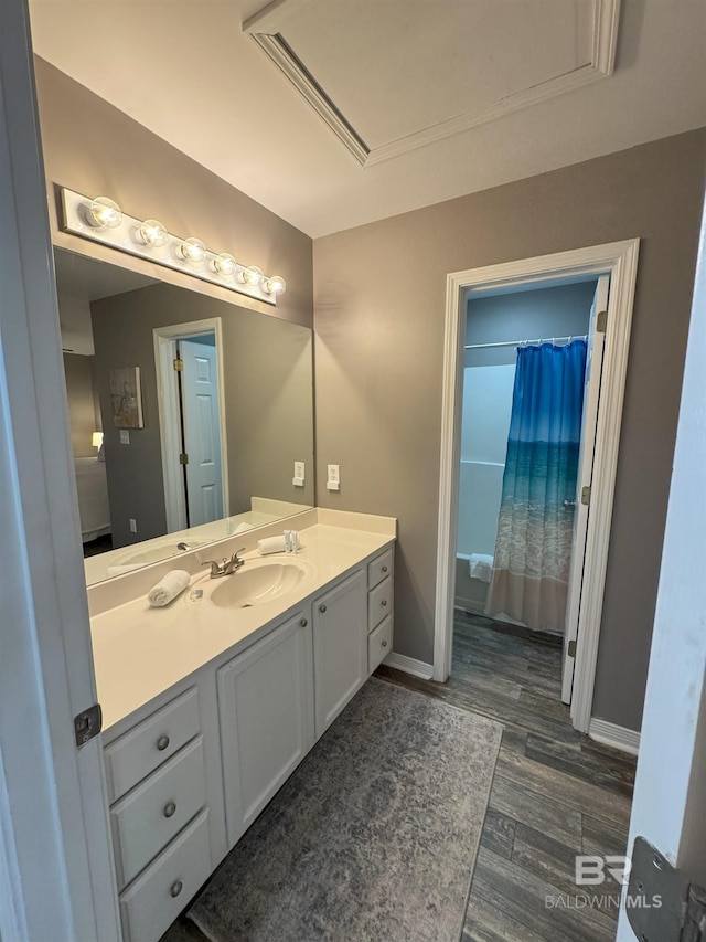 1117 W Lagoon Ave Unit 9, Gulf Shores, AL 36542 - bathroom featuring vanity, wood finished floors, curtained shower, and baseboards