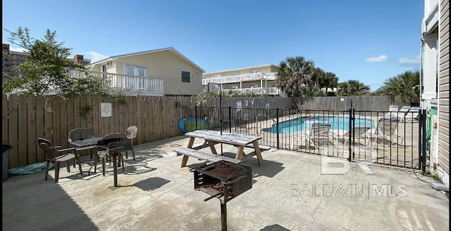 1117 W Lagoon Ave Unit 9, Gulf Shores, AL 36542 - fenced backyard featuring a community pool and a patio