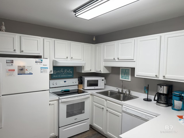 1117 W Lagoon Ave Unit 9, Gulf Shores, AL 36542 - kitchen with white appliances, under cabinet range hood, a sink, and white cabinetry