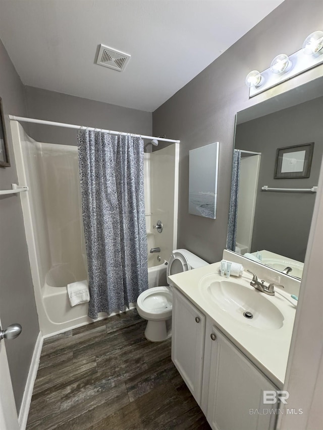 1117 W Lagoon Ave Unit 9, Gulf Shores, AL 36542 - bathroom featuring shower / bath combo, toilet, vanity, and wood finished floors