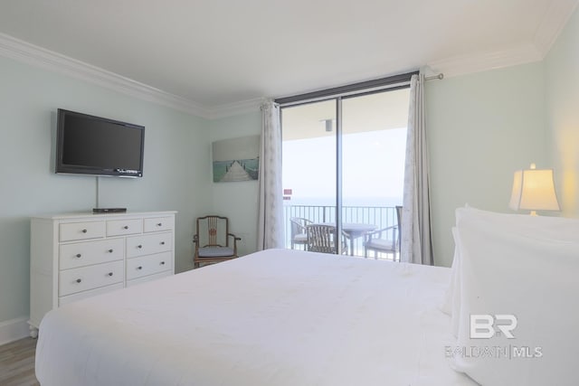 bedroom featuring access to exterior, wood finished floors, and ornamental molding