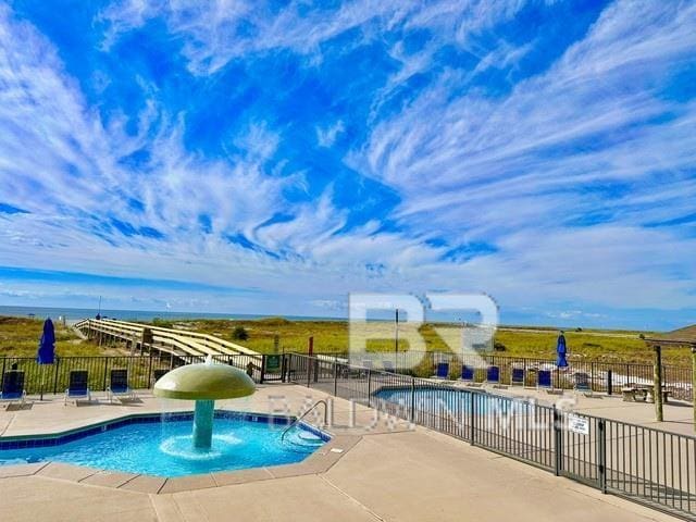 pool featuring fence and a patio area