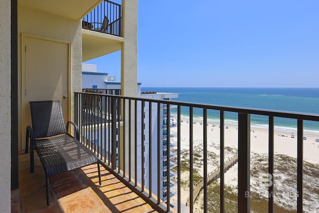 balcony with a beach view and a water view