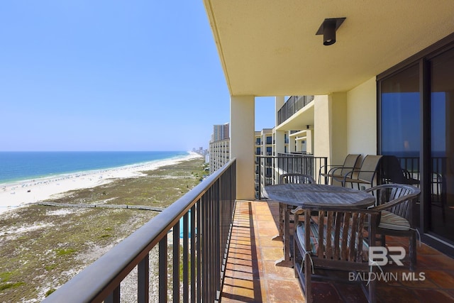 balcony featuring a water view and a beach view