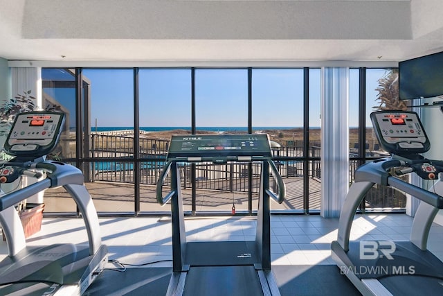 exercise room with expansive windows and a textured ceiling