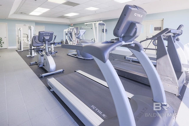 workout area with baseboards and a drop ceiling