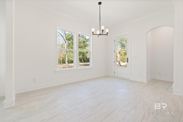 spare room with a notable chandelier