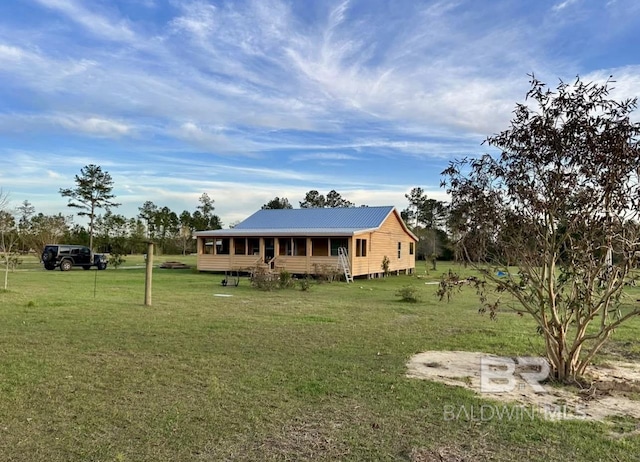 24996 Cowpen Creek Rd, Robertsdale, AL 36567 - view of front of house with a front yard, metal roof, and a sunroom