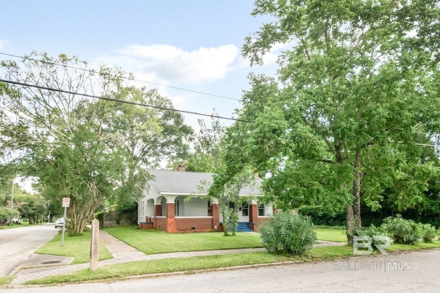 101 S Carlen St, Mobile, AL 36606 - obstructed view of property with a front lawn, crawl space, brick siding, and a chimney