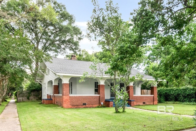 101 S Carlen St, Mobile, AL 36606 - view of front facade with crawl space, brick siding, and roof with shingles