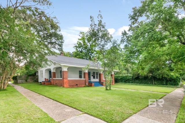 101 S Carlen St, Mobile, AL 36606 - view of front of home featuring a porch, brick siding, a front lawn, crawl space, and a chimney