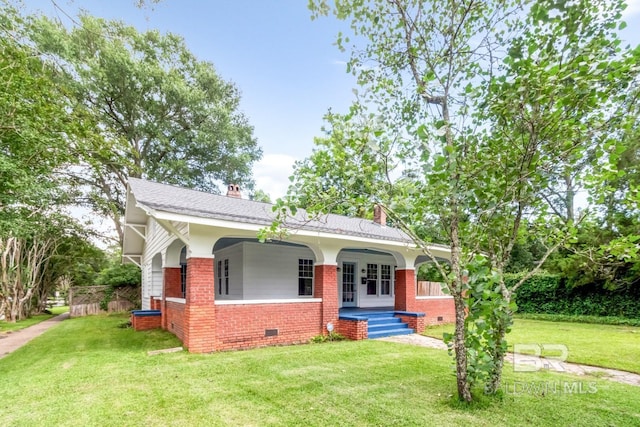 101 S Carlen St, Mobile, AL 36606 - view of front of house with brick siding, crawl space, covered porch, a chimney, and a front yard