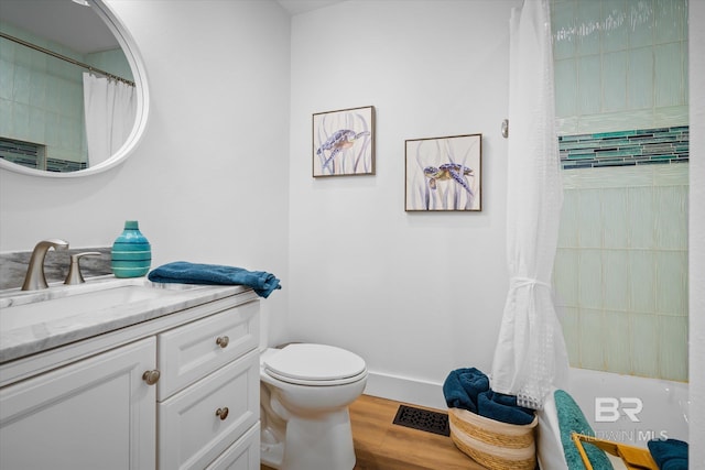 bathroom with hardwood / wood-style floors, vanity, a shower with shower curtain, and toilet