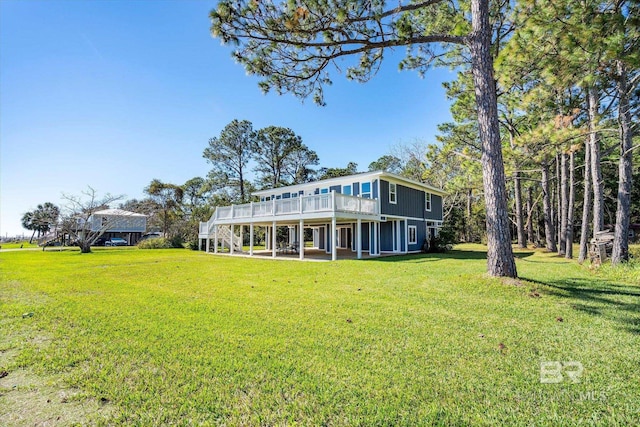 exterior space with a patio area, a wooden deck, and a front lawn