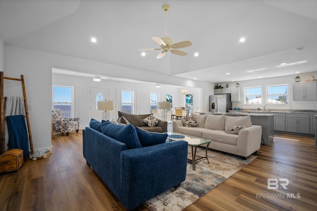 living room featuring ceiling fan, wood-type flooring, sink, and high vaulted ceiling