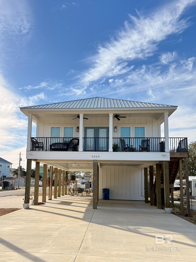 exterior space with a carport and ceiling fan