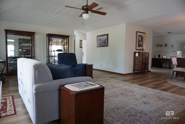 living room with hardwood / wood-style floors and ceiling fan