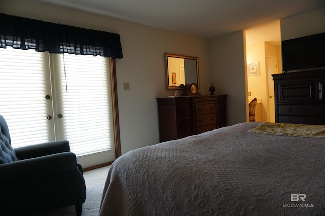 bedroom featuring light carpet