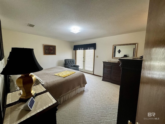 carpeted bedroom featuring a textured ceiling