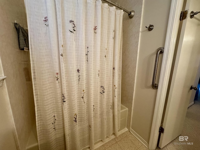 bathroom featuring tile patterned flooring and shower / bath combo with shower curtain