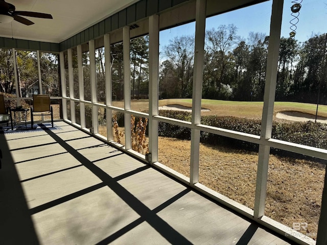 unfurnished sunroom with ceiling fan