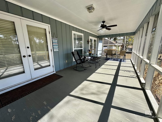 unfurnished sunroom with ceiling fan and french doors