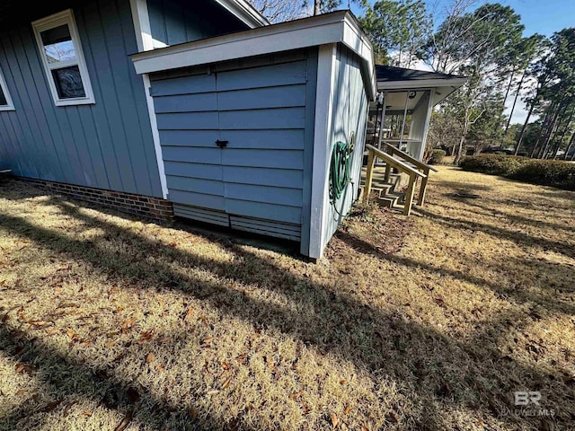 view of outdoor structure featuring a lawn