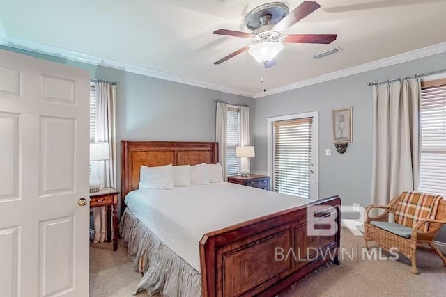 carpeted bedroom with ornamental molding and ceiling fan