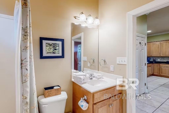 bathroom featuring backsplash, toilet, tile floors, and vanity