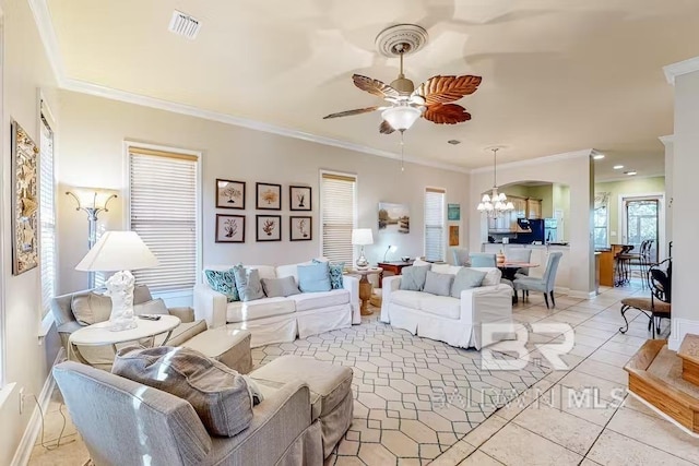 living room featuring ornamental molding, plenty of natural light, ceiling fan with notable chandelier, and light tile floors