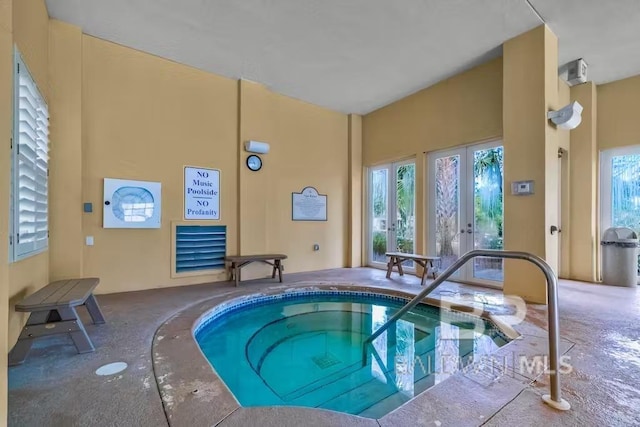 view of pool featuring french doors and an indoor in ground hot tub