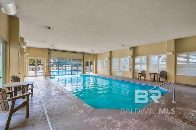 view of pool featuring french doors