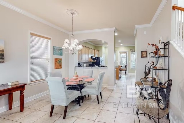 dining room featuring plenty of natural light, crown molding, and a notable chandelier