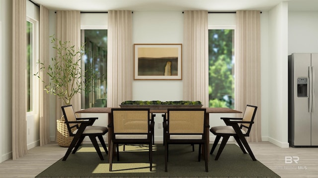 dining area with baseboards, light wood-style floors, and plenty of natural light