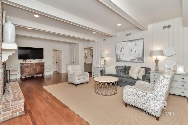 living room with beam ceiling and hardwood / wood-style floors