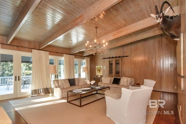 living room with french doors, wood ceiling, wooden walls, beamed ceiling, and a chandelier