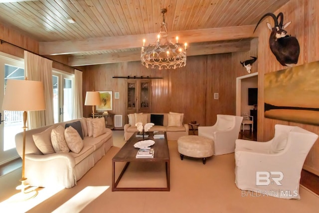 living room with a wealth of natural light, wood walls, beamed ceiling, and an inviting chandelier