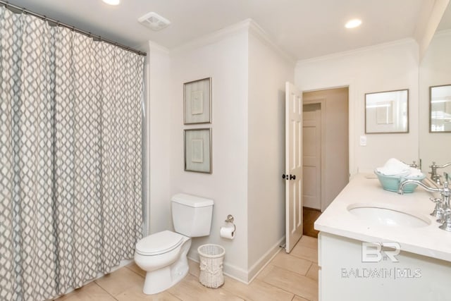 bathroom with tile patterned floors, vanity, toilet, and ornamental molding