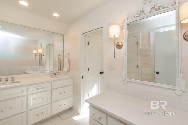 bathroom with tile patterned flooring, vanity, and toilet