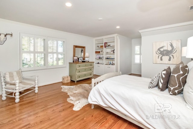 bedroom featuring hardwood / wood-style floors and crown molding