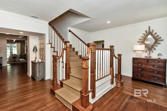 stairs featuring hardwood / wood-style floors and ornamental molding