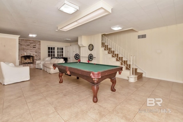 playroom with light tile patterned flooring, billiards, and a brick fireplace