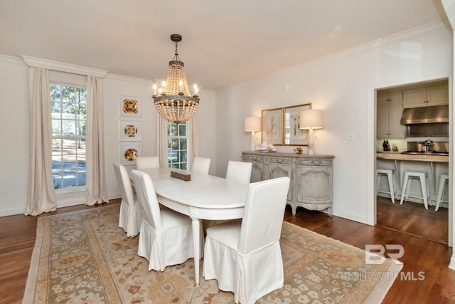 dining area with a notable chandelier, a healthy amount of sunlight, dark hardwood / wood-style flooring, and crown molding