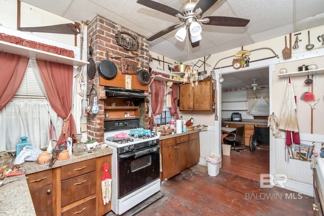 kitchen with ceiling fan, range with gas cooktop, and extractor fan